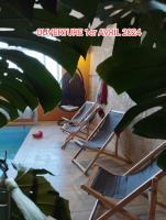 a row of lounge chairs in a room with a plant at Gite la Péraie - Le Roseau in Treize-Vents