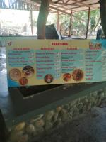 a sign for a menu of a restaurant at Waterfall Hostel and restaurant in Los Anastacios