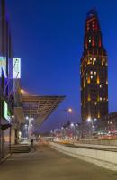 a tall building with a clock tower at night at Holiday Inn Express Amiens, an IHG Hotel in Amiens