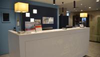 a white counter in a room with lights at Holiday Inn Express Amiens, an IHG Hotel in Amiens