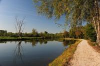 a dirt road next to a river with trees at Holiday Inn Express Amiens, an IHG Hotel in Amiens