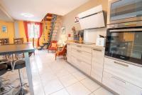 a kitchen with stainless steel appliances and a dining room at Le Sapin Parasol - Maison pour 7 pers. in Lussault-sur-Loire