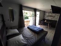 a bedroom with a bed and a table with a dining room at Family&#39;s Camping Le Savoy in Challes-les-Eaux