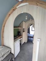 a kitchen with an archway in a tiny house at Family&#39;s Camping Le Savoy in Challes-les-Eaux
