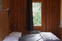 a bedroom with a bed in front of a window at Family&#39;s Camping Le Savoy in Challes-les-Eaux