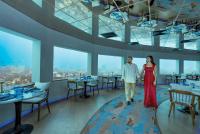 un hombre y una mujer caminando por un restaurante en OBLU SELECT Lobigili - Premium All-Inclusive with Free Transfers, en Male