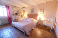 a bedroom with a white bed and two chairs at typical provençal farm house close to l&#39;isle sur la sorgue - 12 persons in Cavaillon
