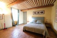 a bedroom with a bed with a wooden ceiling at typical provençal farm house close to l&#39;isle sur la sorgue - 12 persons in Cavaillon