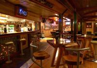 a bar with tables and stools in a restaurant at Kings Ohakune in Ohakune