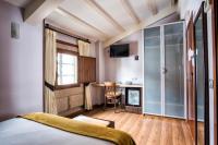 A bed or beds in a room at Hotel Alda Bonaval