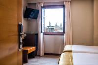 A bed or beds in a room at Hotel Alda Bonaval