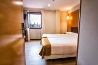 A bed or beds in a room at Hotel Alda Bonaval