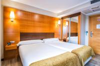 A bed or beds in a room at Hotel Alda Bonaval
