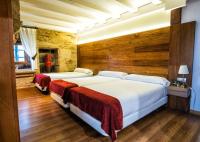 A bed or beds in a room at Hotel Alda Bonaval