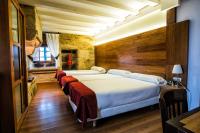 A bed or beds in a room at Hotel Alda Bonaval