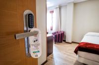 A bed or beds in a room at Hotel Alda Bonaval