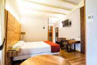 A bed or beds in a room at Hotel Alda Bonaval