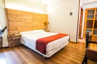 A bed or beds in a room at Hotel Alda Bonaval