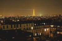 a view of a city at night with the eiffel tower at Luxury flat with amazing view on Eiffel Tower in Paris
