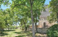 an old stone house with trees in front of it at Amazing Home In Barjac With 3 Bedrooms, Wifi And Outdoor Swimming Pool in Barjac