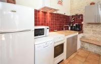 a kitchen with white appliances and red tiles at Amazing Home In Barjac With 3 Bedrooms, Wifi And Outdoor Swimming Pool in Barjac