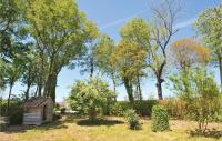 an old wooden shack in a garden with trees at Amazing Home In Barjac With 3 Bedrooms, Wifi And Outdoor Swimming Pool in Barjac