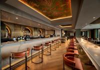 a bar with a row of stools in a restaurant at The Winchester Hotel by NEWMARK in Cape Town