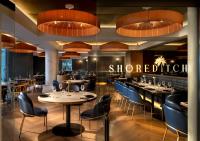 a restaurant with tables and chairs and a sign at The Winchester Hotel by NEWMARK in Cape Town