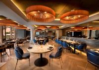 a restaurant with tables and chairs and a bar at The Winchester Hotel by NEWMARK in Cape Town