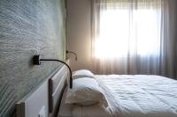 a bed in a room with a window at Suite Dall'Alba al Tramonto in Mogliano Veneto
