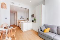 a living room with a couch and a table at Les Appartements de Grenoble in Grenoble