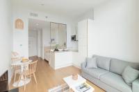 a living room with a couch and a table at Les Appartements de Grenoble in Grenoble