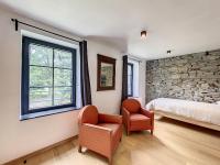 a bedroom with a bed and a stone wall at Gîte à Esneux - A La Belle Epoque d&#39;Esneux in Esneux