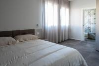 a bedroom with a bed and a large window at Suite Dall'Alba al Tramonto in Mogliano Veneto