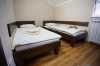 two beds in a small room with wooden floors at STARA VAROŠ in Topola