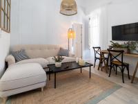 A television and/or entertainment centre at Bright and Elegant Gran Via apartments