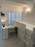 a room with a bed and a desk and a table at Maison indépendante 7 minutes RER B in Antony