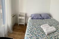 a bedroom with a bed with two towels on it at Maison indépendante 7 minutes RER B in Antony