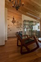 a living room with a chair and a chandelier at Sunnylands B&amp;B 日光小鎮民宿 in Dayin