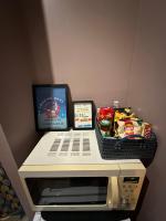 a desk with a basket of snacks and a computer monitor at La Tiny : Adorable petit studio &#47;parking gratuit. in Angoulême