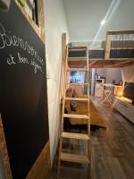 a room with bunk beds and a desk and a chalkboard at La Tiny : Adorable petit studio &#47;parking gratuit. in Angoulême