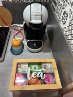 a box of food sitting next to a coffee maker at La Tiny : Adorable petit studio &#47;parking gratuit. in Angoulême