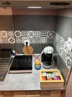 a model of a kitchen with black and white tiles at La Tiny : Adorable petit studio &#47;parking gratuit. in Angoulême