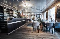 a restaurant with a bar with tables and chairs at Hotel & Restaurant Rizzelli Superior in Neustadt an der Aisch