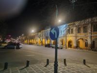 a street sign on the side of a street at night at Garage studio in Bistriţa