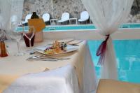 a table with a plate of food and wine glasses at Hotel Degli Haethey in Otranto