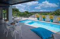 a patio with a swimming pool and a table and chairs at Tropic &amp; Chic in Sainte-Anne