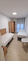 A bed or beds in a room at Apartamentos Gran Socaire de Noja