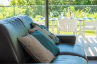 a blue couch with pillows sitting on a patio at Tropic &amp; Chic in Sainte-Anne