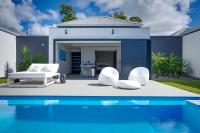 a villa with a swimming pool and a house at Tropic &amp; Chic in Sainte-Anne